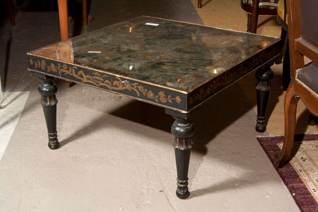 A painted low square coffee or cocktail table, circa 1940s, the top with églomisé glass of chinoiserie scene, over an apron with hand-painted decoration of pagoda and foliate, raised on bulbous legs. Stamped Jansen.